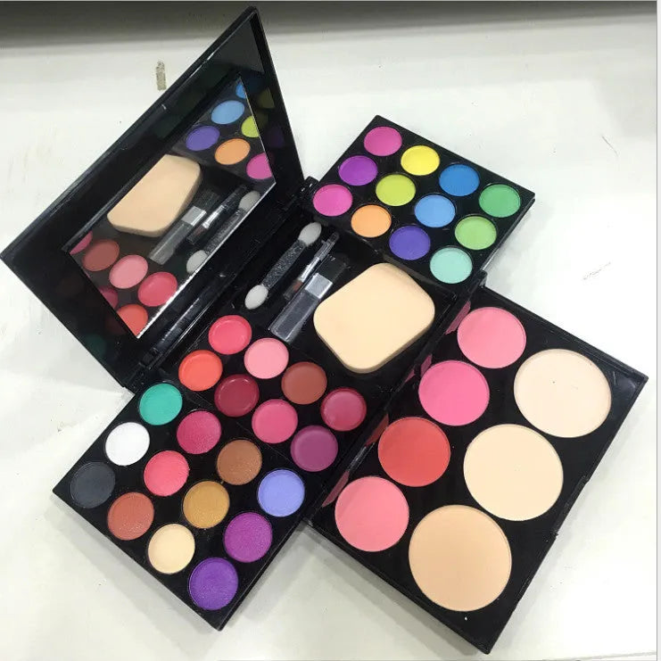Three-layer makeup box set open showing 24 colour eyeshadow, 8 colour lipstick, 4 colour blush, powder cakes and mirror