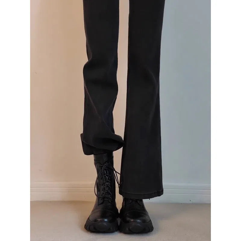 Black thick-soled motorcycle boots with back zipper, lace-up front, round toe, and rubber sole on a neutral background