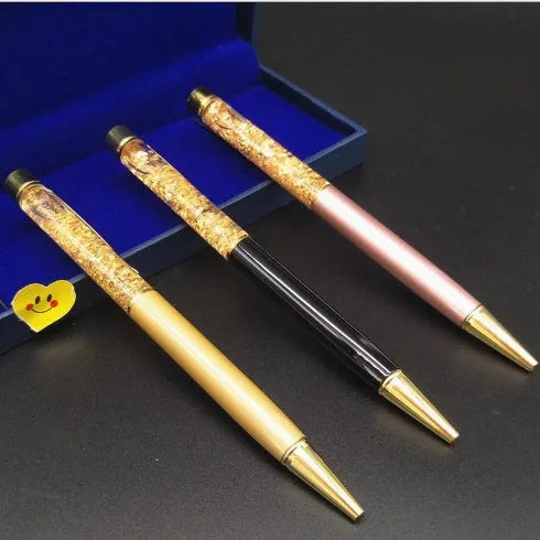 Gold foil metal ballpoint pen 13.8cm with 1mm tip on white background