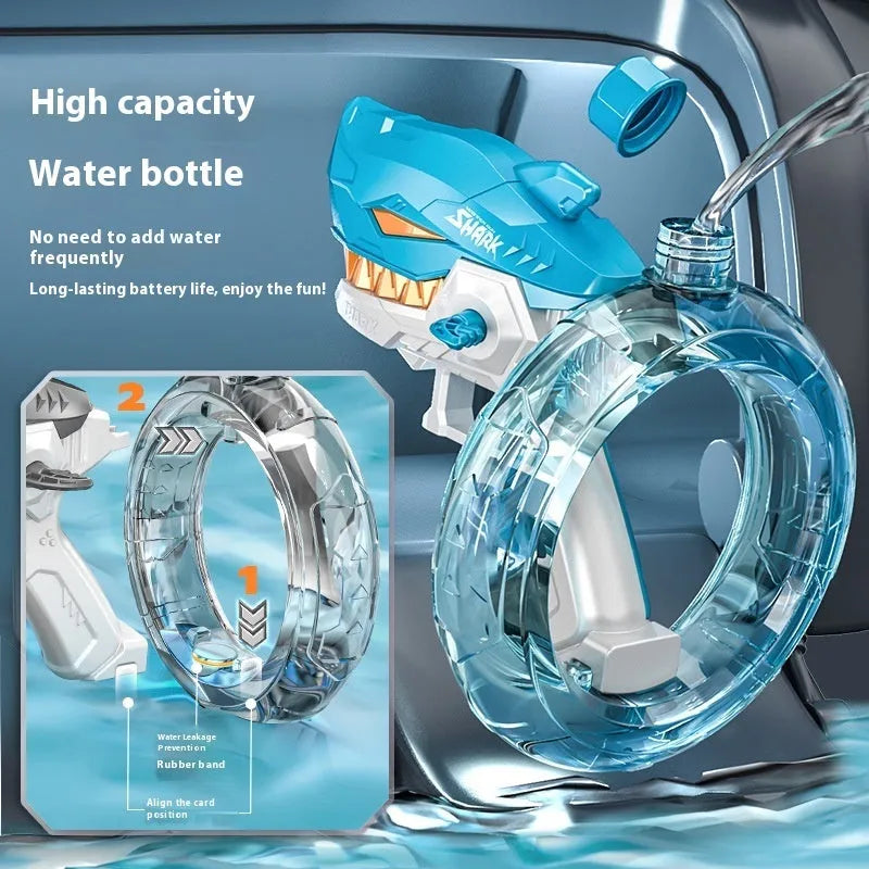 Blue Shark-shaped electric water gun toy with large tank on a sandy beach