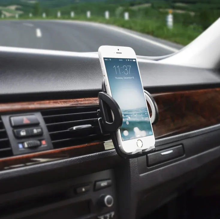 Black universal mobile phone holder clipped to car air conditioning outlet