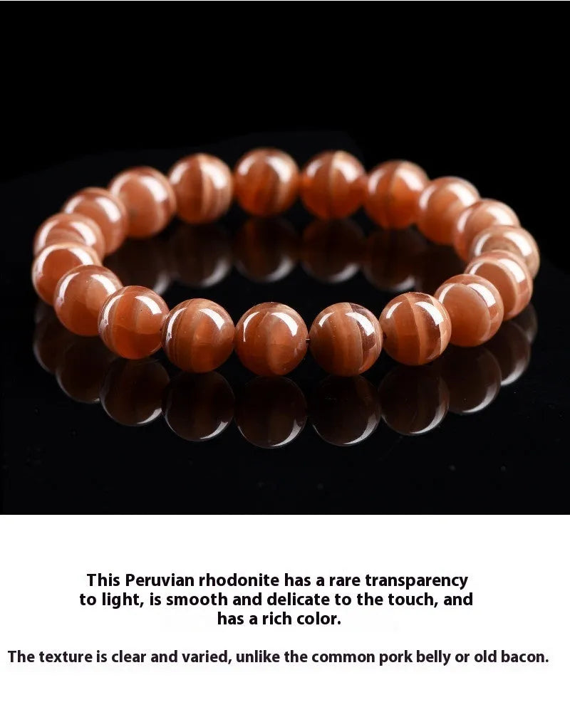 Natural Old Mine Rhodochrosite round bead bracelet with geometric design on wrist.