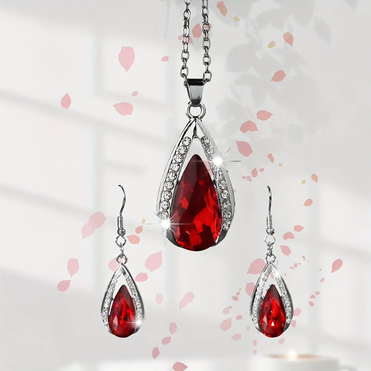 Black and red teardrop-shaped glass pendant necklace and matching earrings set on alloy chain.