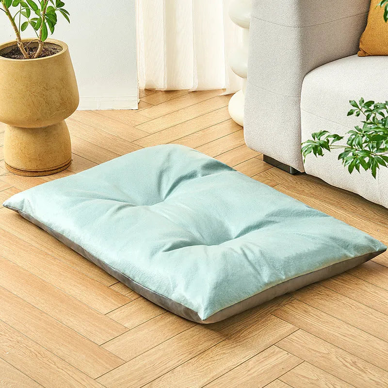 Blue cooling pet bed for cat or small dog showing lightweight foam construction and size scale.