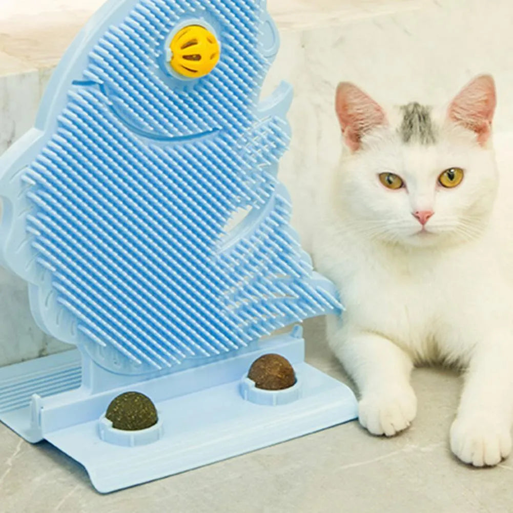 Blue fish-shaped cat wall scratcher toy with brush, catnip balls, and a bell on a white base.