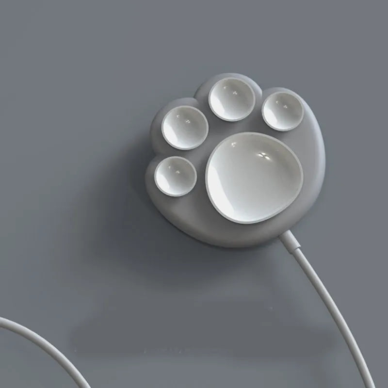 Pink cat claw sucker wireless charger with USB cable on a desk