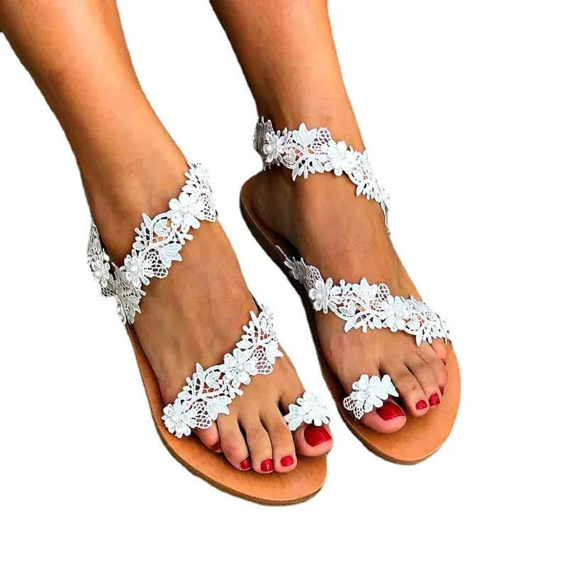 White women's flat sandals with rhinestone floral detail on artificial PU upper