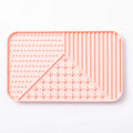 Silicone pet licking mat with textured surface and suction cup base in grey, khaki, or pink colour.