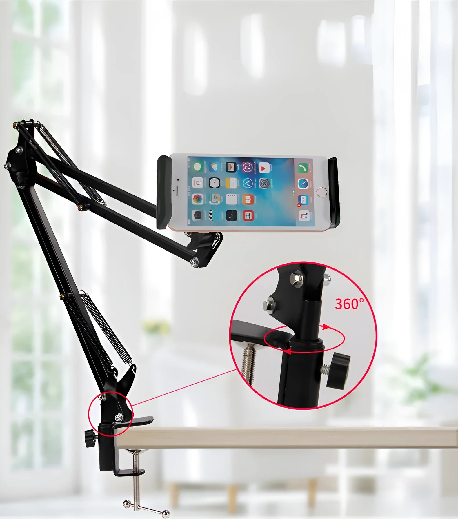 A black adjustable stand holding a mobile phone on a table.