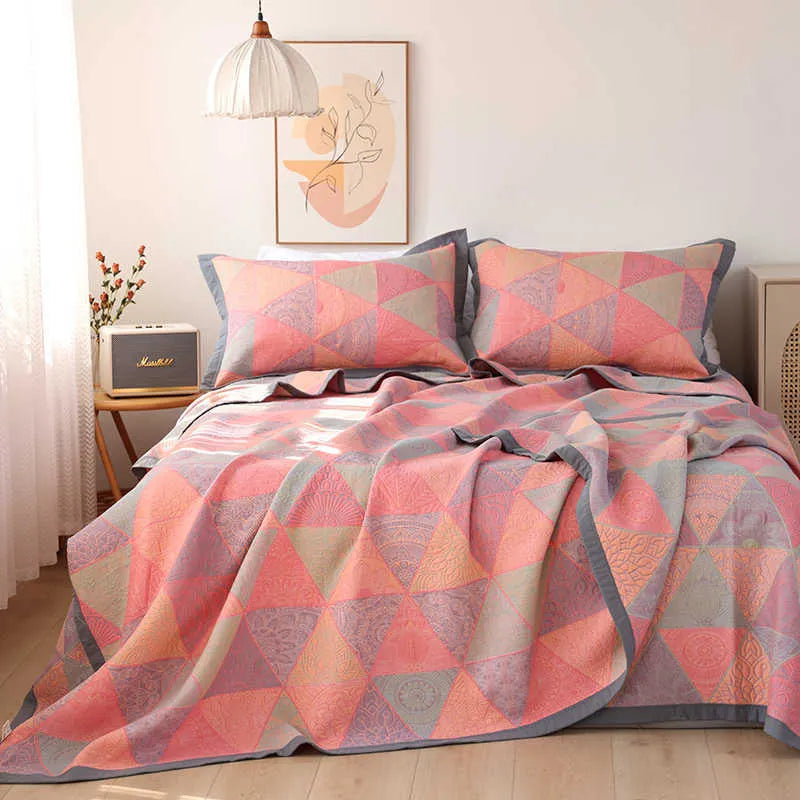Three-piece cotton gauze bed set with floral plants and flowers pattern, showing blanket and pillowcases.