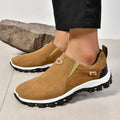 A pair of grey round-toe men's slip-on shoe covers made of PU with a rubber sole.