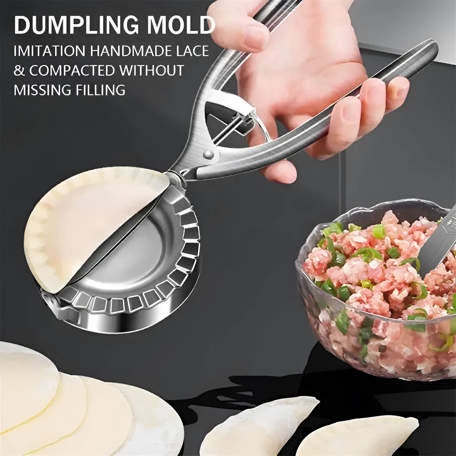Silver-colour stainless steel manual dumpling mould on a kitchen counter.