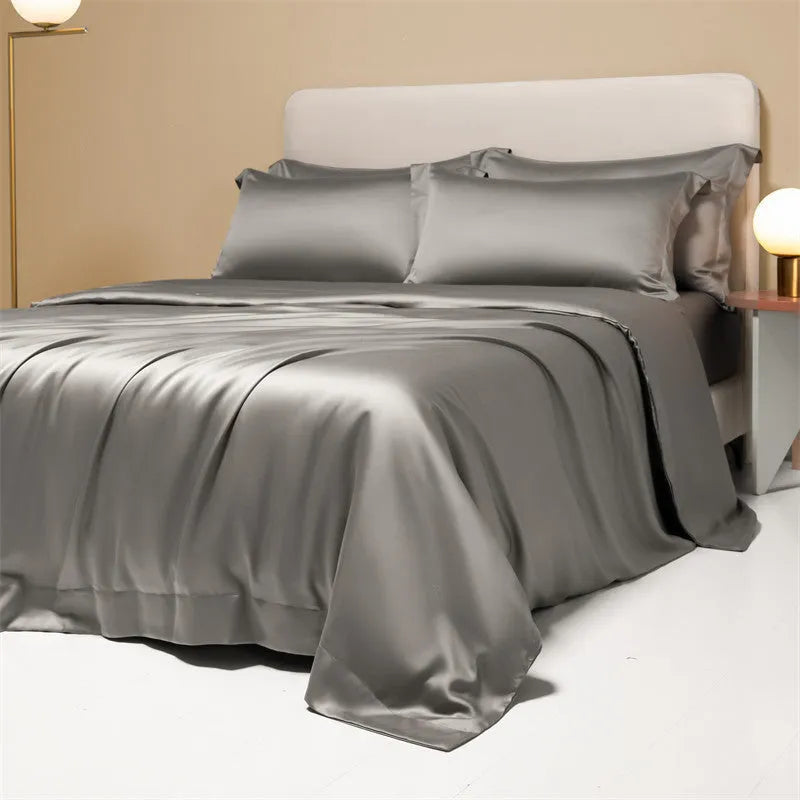 Aurora Blue 200 thread count Tencel duvet cover, fitted sheet, and pillowcases laid on a modern bed.