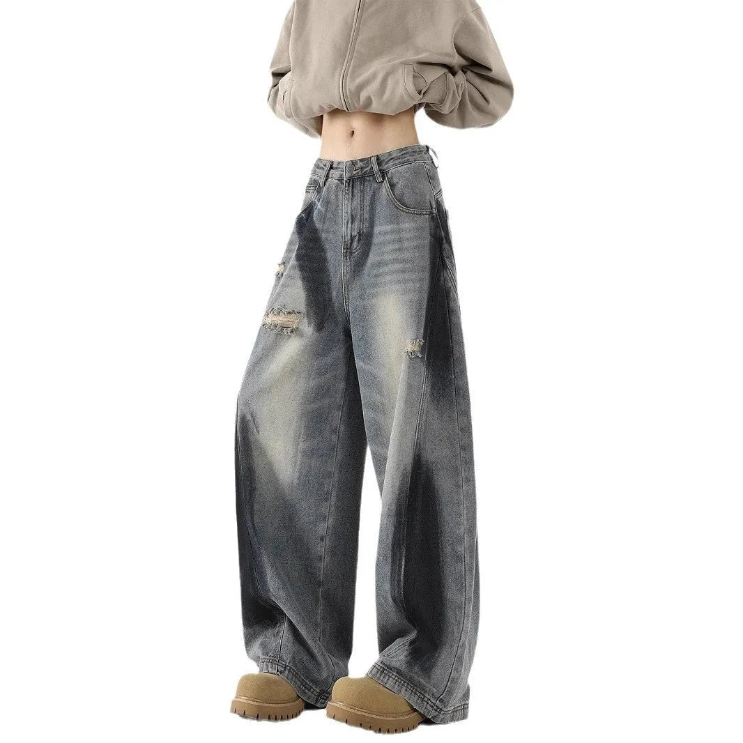 Blue men's loose fit jeans featuring a splash-ink pattern and ripped knee detailing.