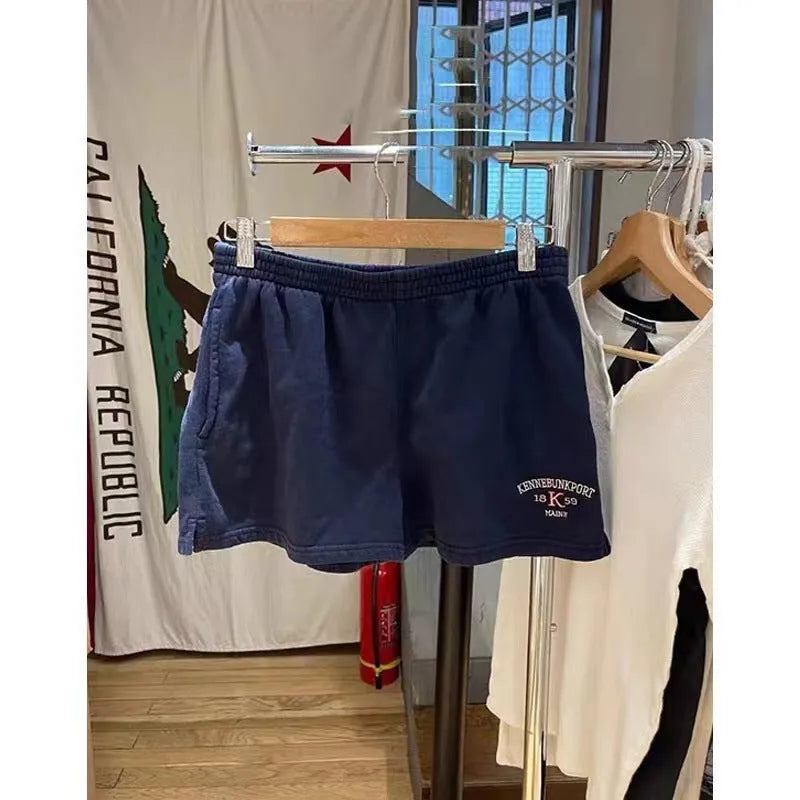 Women's dark blue cotton high top sports shorts with white flag embroidery and adjustable side ties
