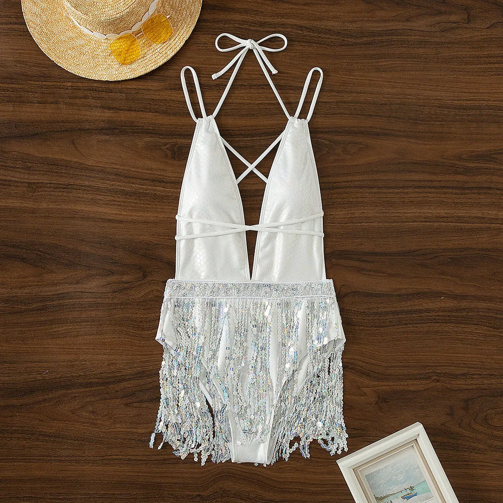 White deep V-neck one-piece swimsuit with tassel detail on a briefs style bottom
