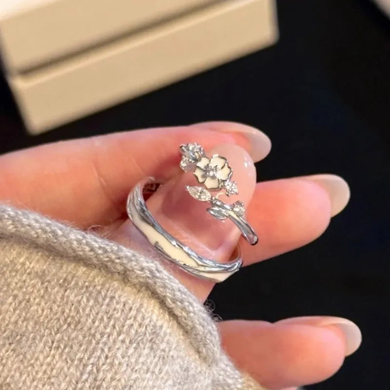 Silver sparkling camellia couple's ring with adjustable opening, floral geometric shape, electroplated finish