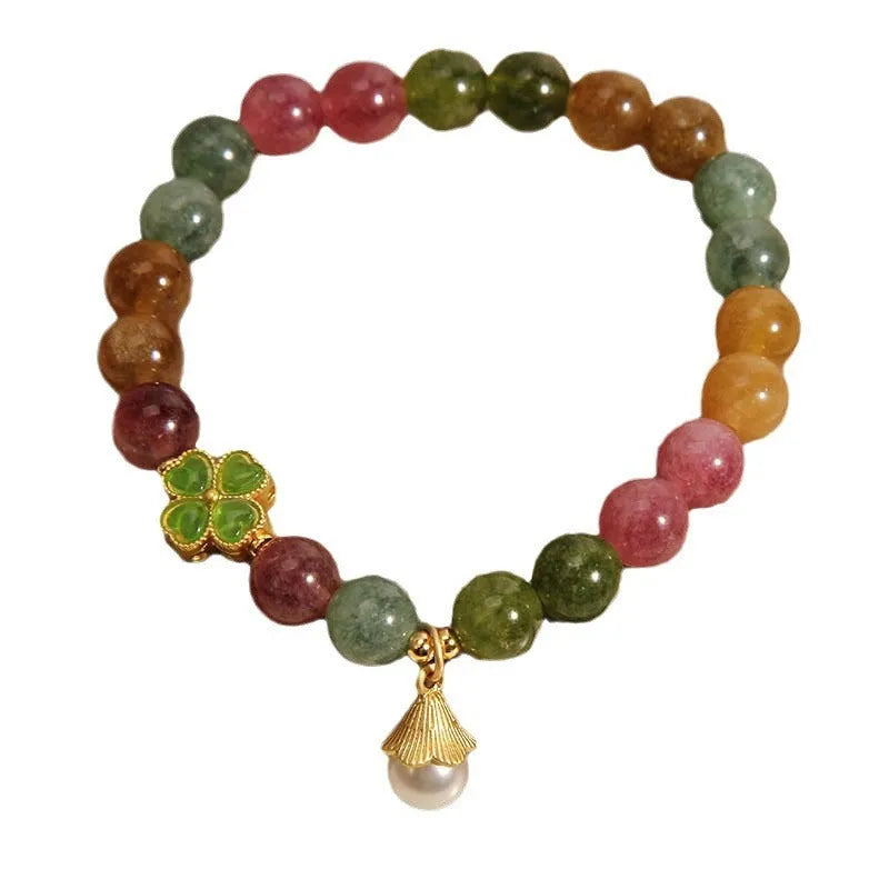 Women's silver-tone bracelet with a drop-shaped four-leaf clover pearl charm and colourful tourmaline stones on a geometric link band.