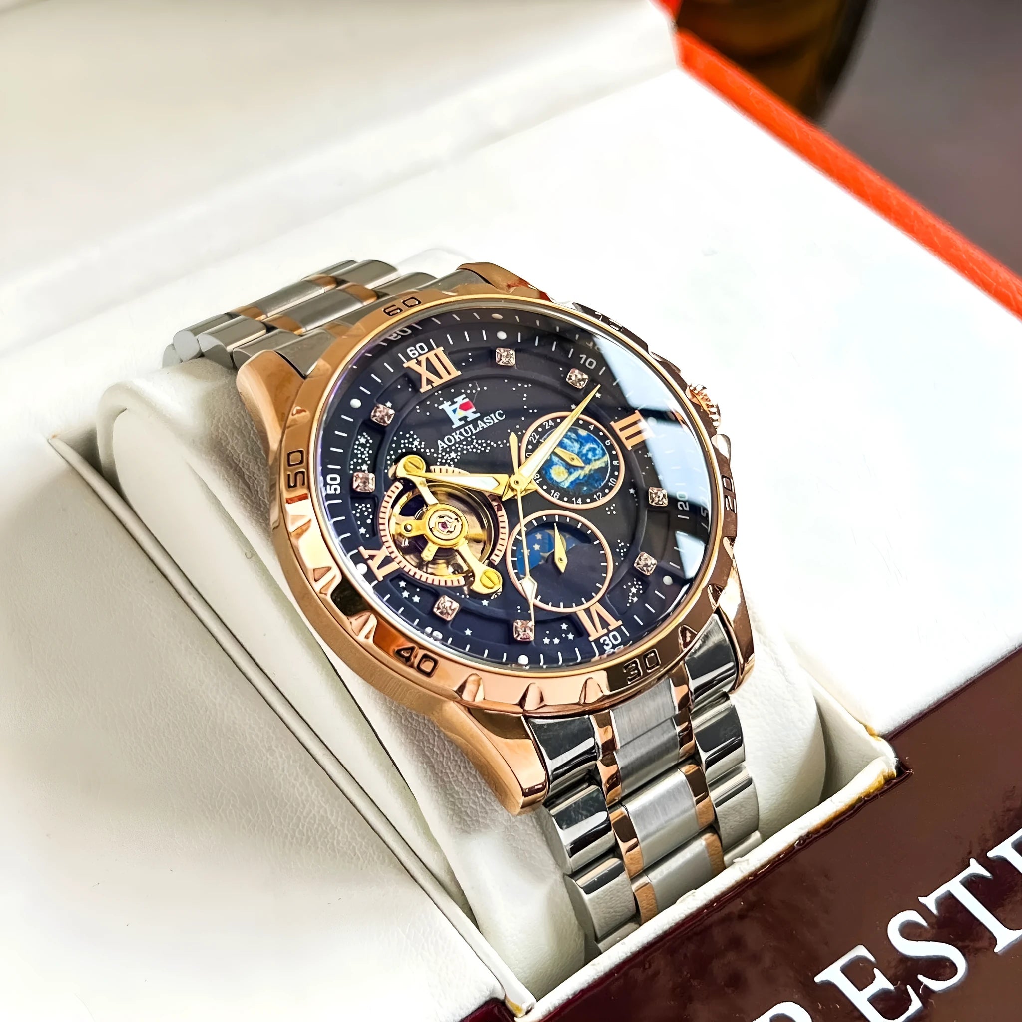 Automatic mechanical men's wristwatch with rose gold case and black dial on a strap.