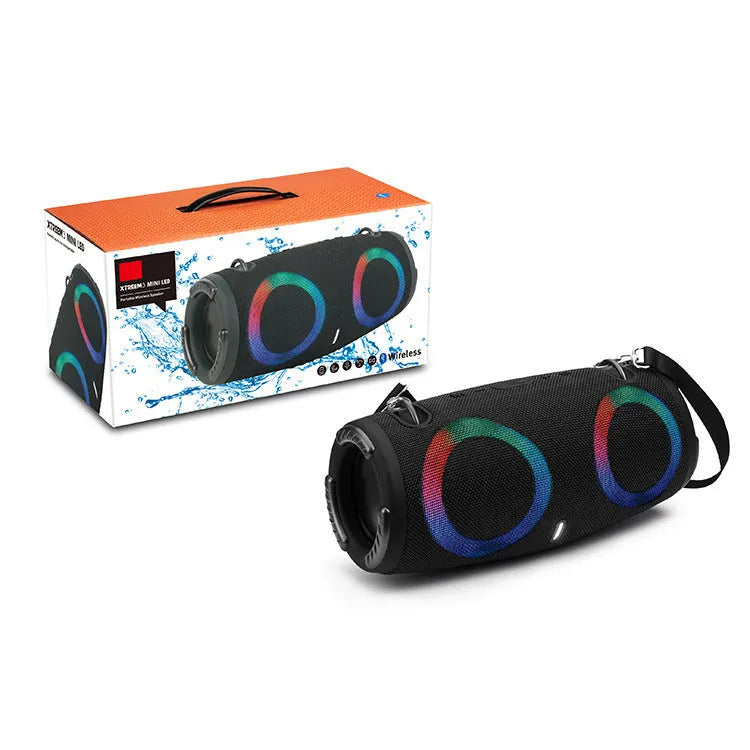 Cylindrical War Drum Bluetooth speaker with coloured RGB lights in a waterproof outdoor setting.