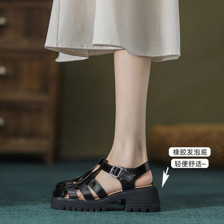 Women's black retro platform sandals with chunky heel, hollow out design, and a buckle fastening.