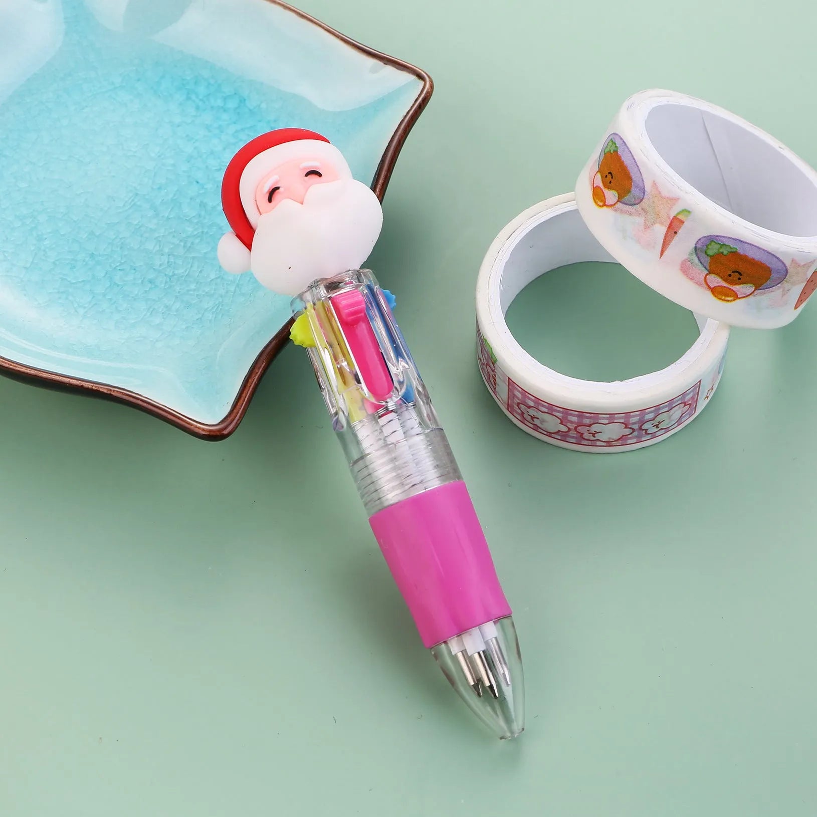 Compact 11cm Christmas ballpoint pen with four colours and festive designs like snowmen and reindeer.