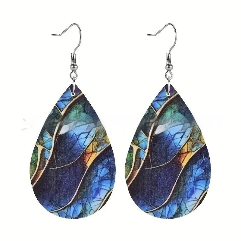 A pair of printed acrylic earrings with a flat branch knot design in a drop shape.