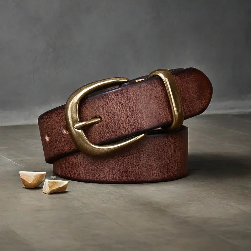 Men's brown leather belt with copper pin buckle on a flat surface