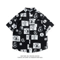 Man wearing a loose fit short sleeve shirt with a full floral printed pattern, buttoned up with a collar.