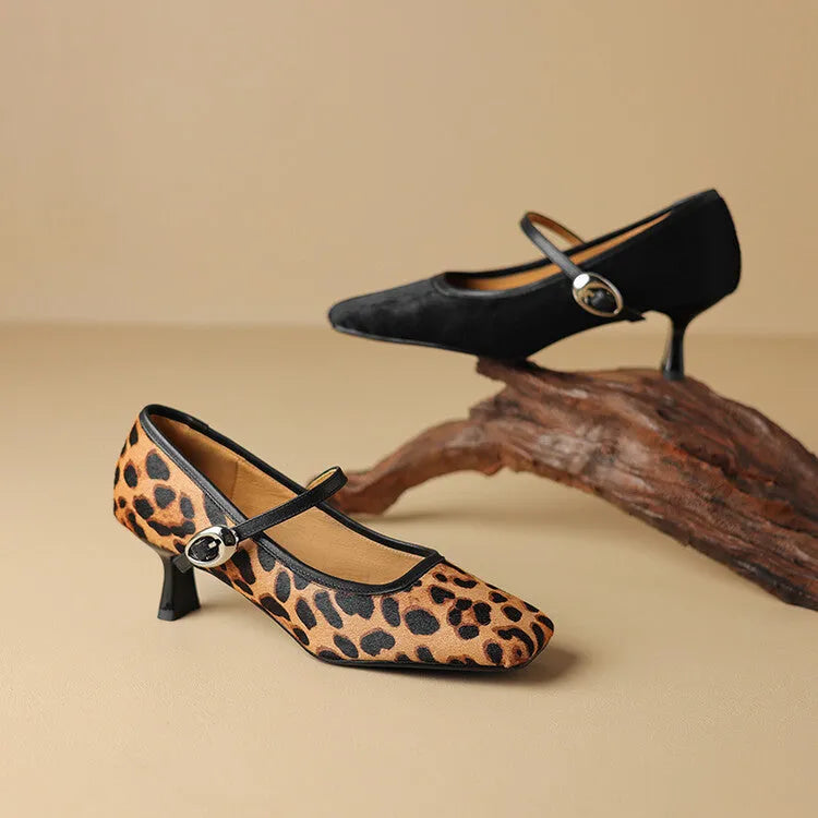 Black women's square toe stiletto ankle-strap heels with horse hair upper and buckle closure.