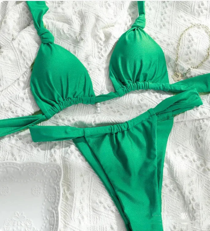 Women's pleated strap knotted bikini swimsuit in a solid colour on a mannequin.