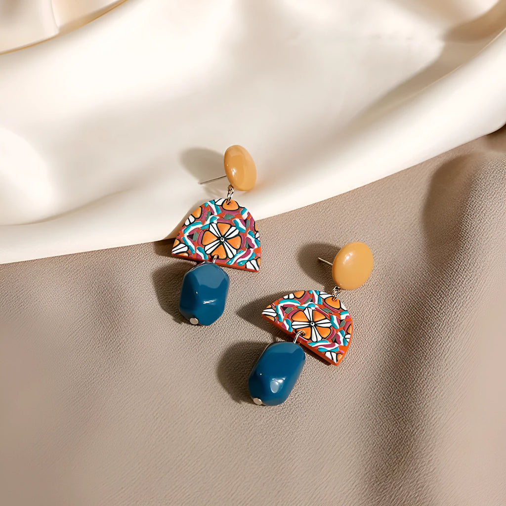 Retro yellow blue contrast acrylic earrings with irregular geometric shapes on white background.