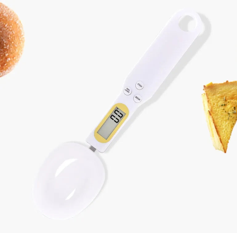 Black digital measuring spoon scale showing 0.0g display on LCD screen with 500g capacity