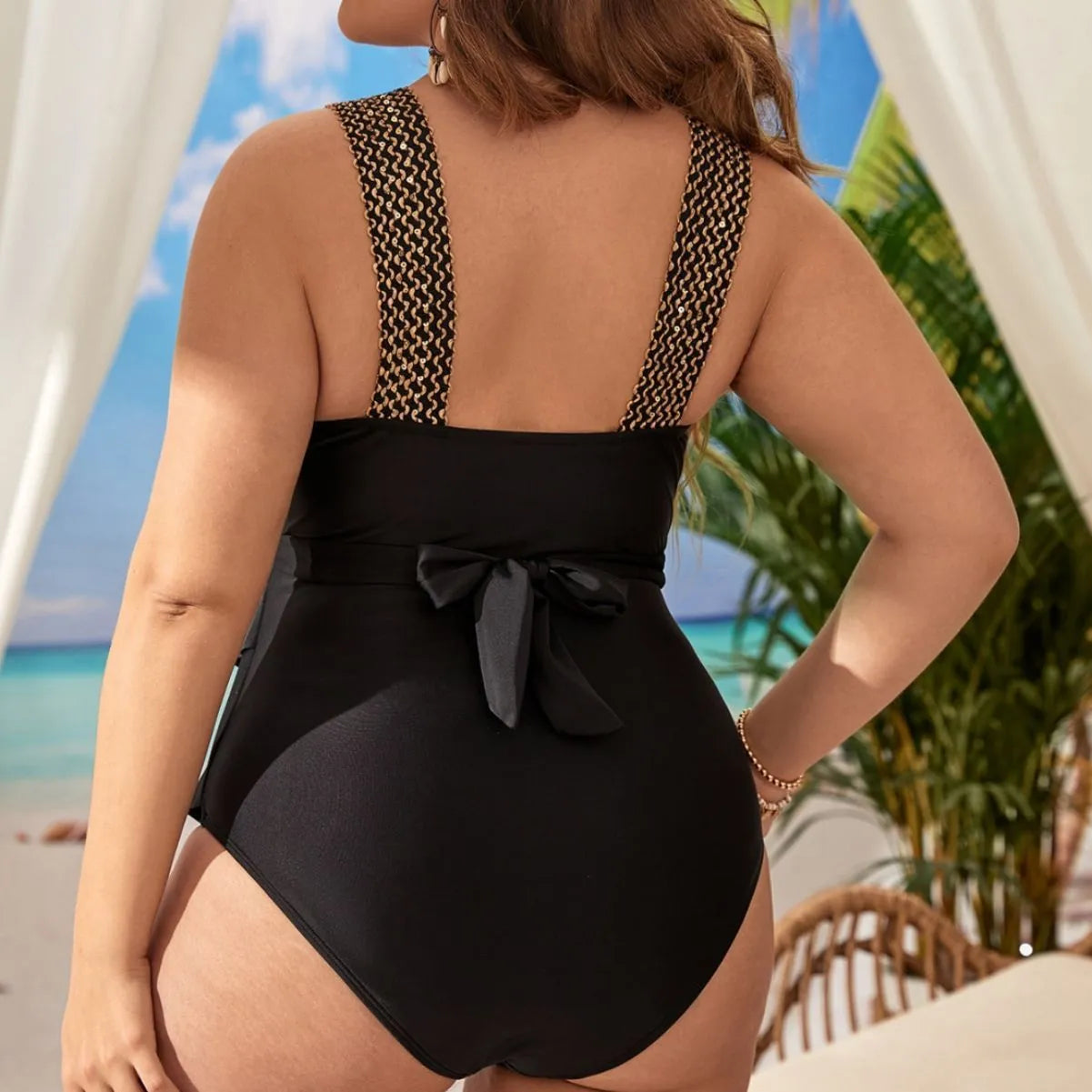 Women's black one-piece sleeveless swimsuit on a hanger, showing built-in chest padding.