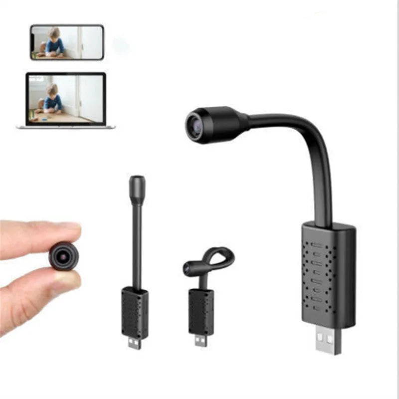 Compact matte black V380 wireless USB security camera on a shelf with a microSD card and USB cable.