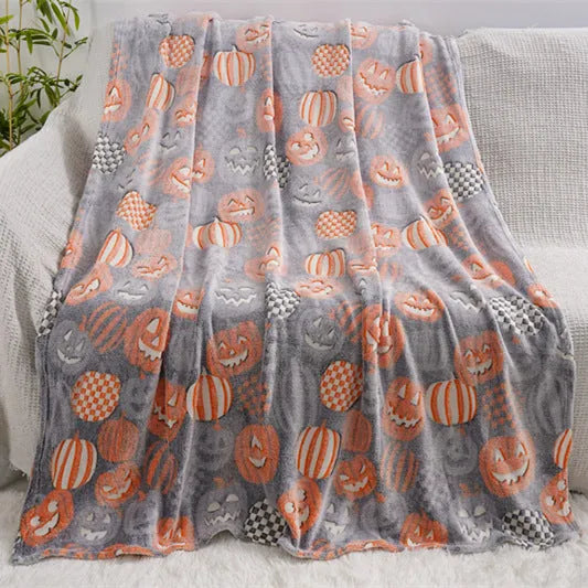 Colourful cartoon print flannel blanket shown draped over a sofa and next to an air conditioner unit.