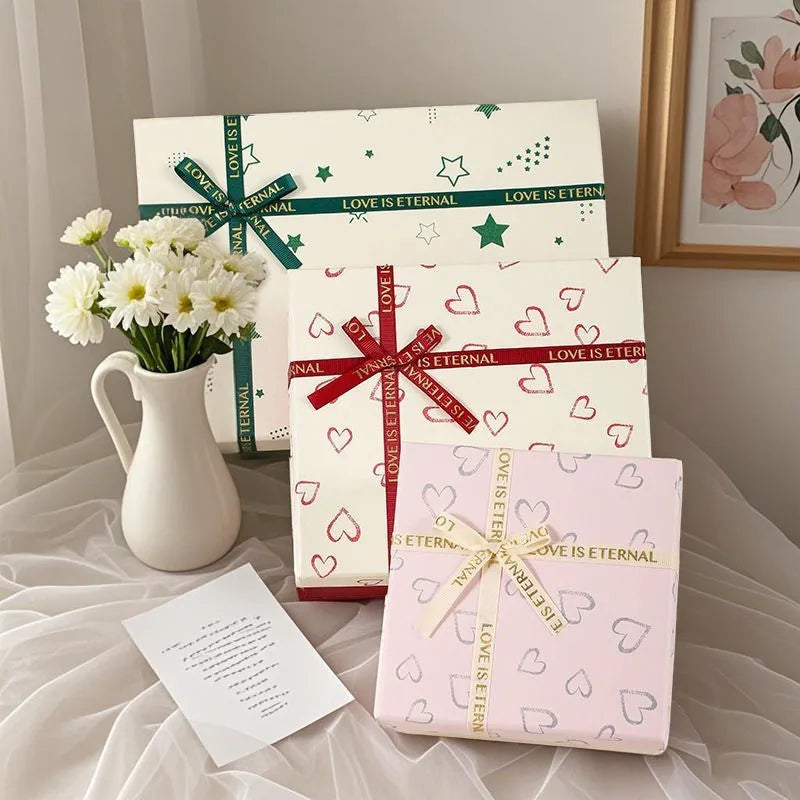 Cardboard gift box with bow in red, green, and pink, multiple sizes for gifts