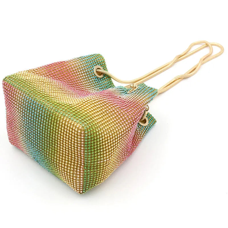 Rainbow coloured rhinestone bucket bag with soft structure and open top, showing sparkling texture.
