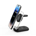 Transparent foldable magnetic wireless charger showing internal coils, unfolded on a table next to a smartphone.