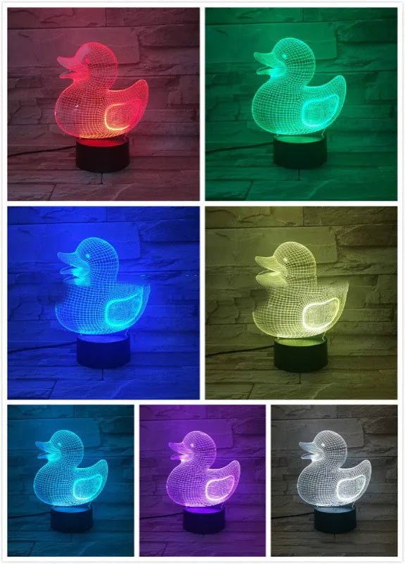 Little Yellow Duck shaped 3D acrylic night light with remote control on a table.