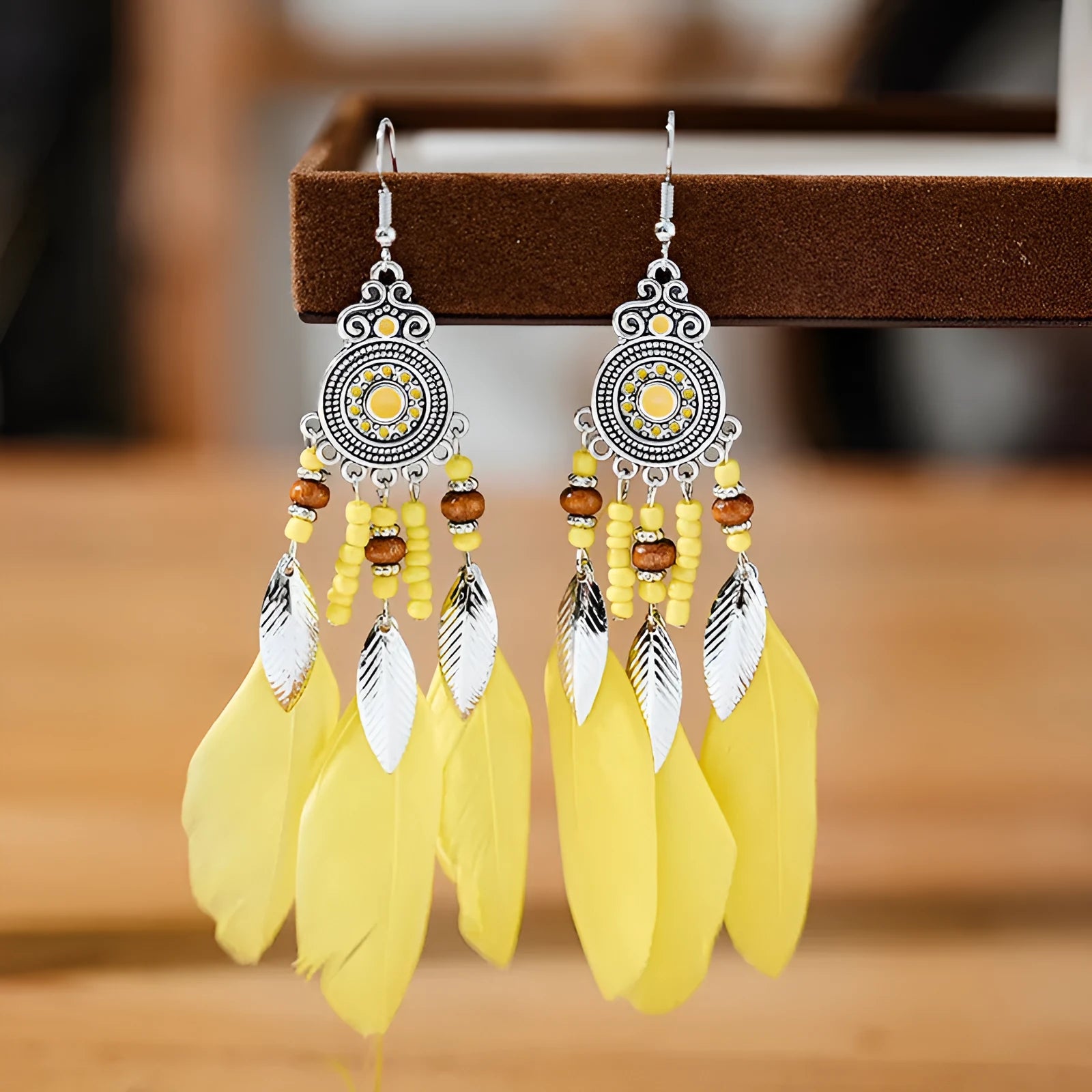Bohemian style round drop feather earrings with leaf design in alloy, showing electroplated finish.