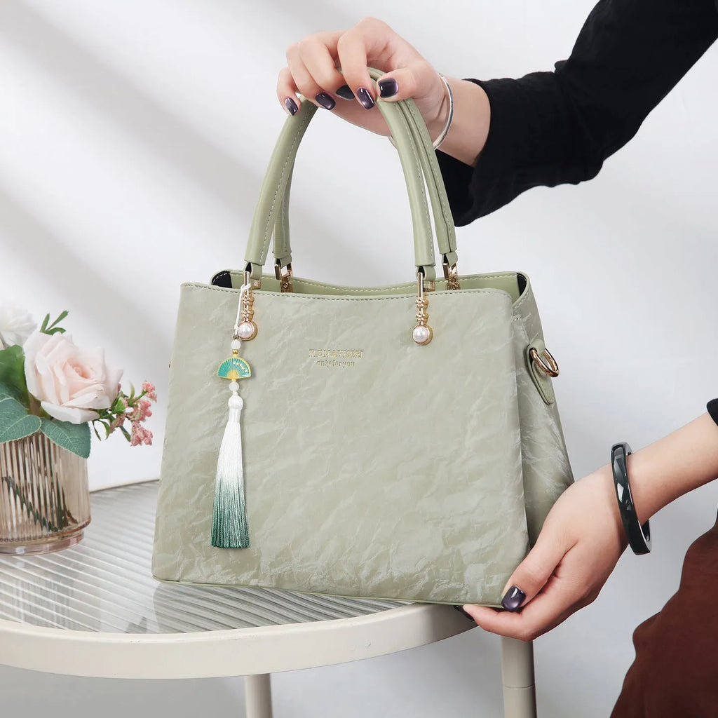 Women's large square shoulder bag in PU leather with a slit pocket, shown in beige colour.
