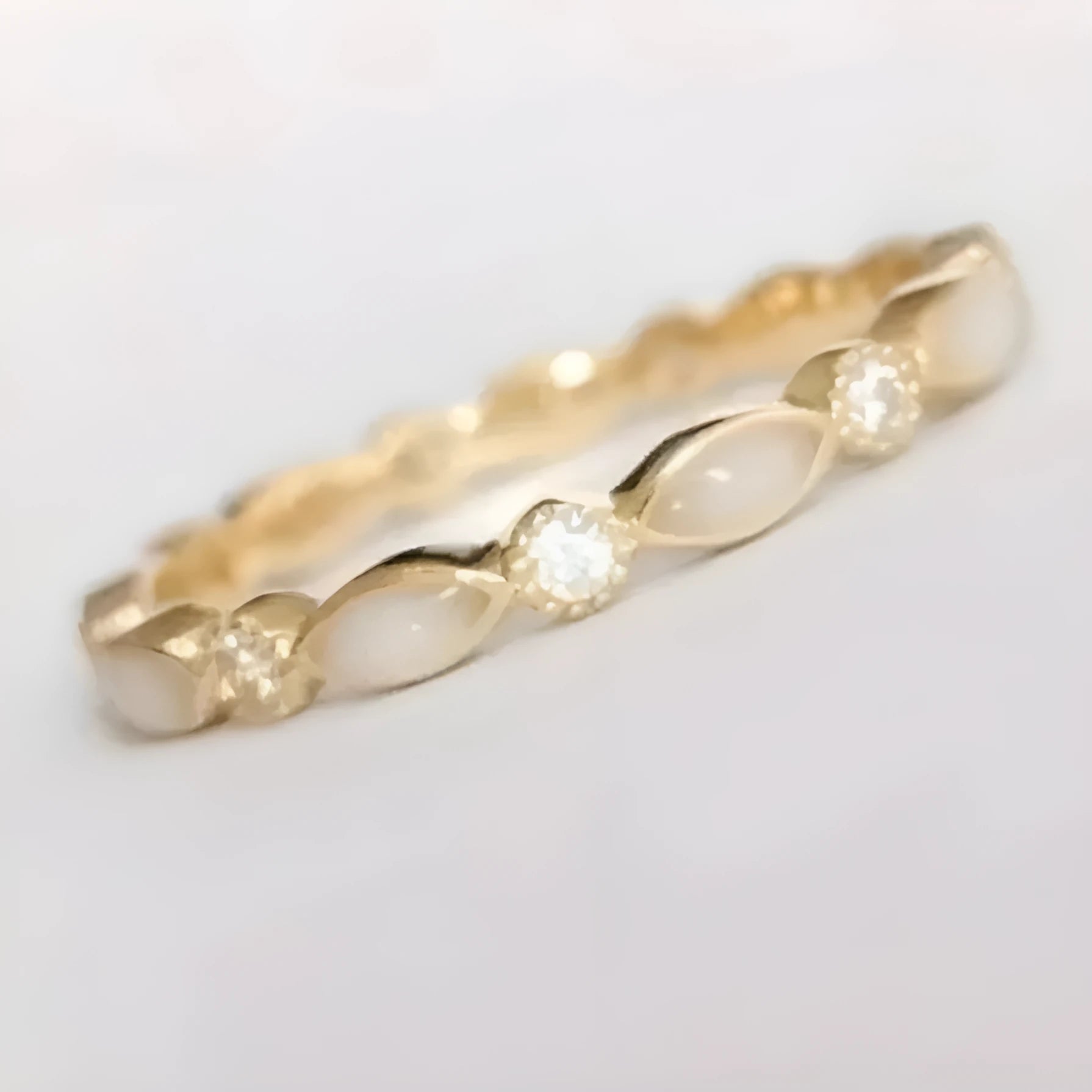 French golden opal open adjustable ring in gold alloy with geometric shape on a white background