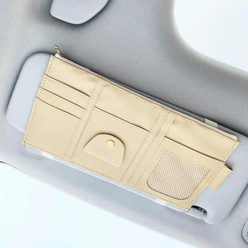 Car sun visor organizer made of PU leather with full leather wrap, showing zippered compartments and sunglasses clip