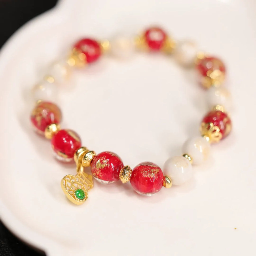 Handmade ethnic style coloured glaze bracelet with gold foil detailing and porcelain hanging gourd design
