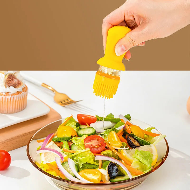 Yellow 2 in 1 oil dispenser with silicone brush next to glass bottle