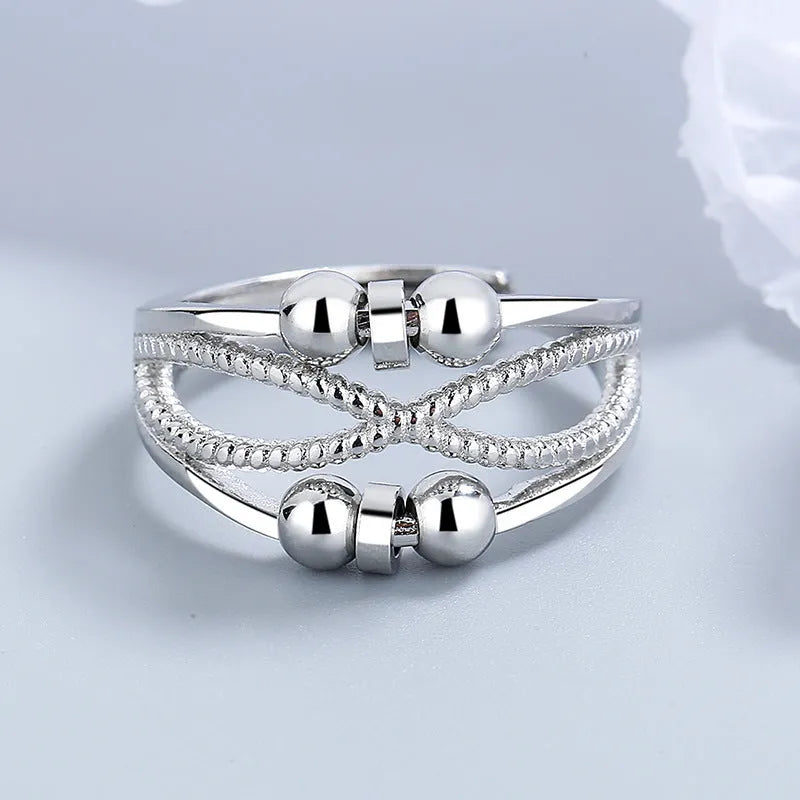 Rotatable copper ring with open design double-layered hollow line construction in platinum colour geometric shape