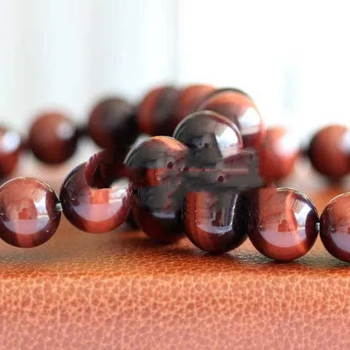 Tiger's eye stone bracelet with lightning cat's eye pattern in a round geometric ethnic style.