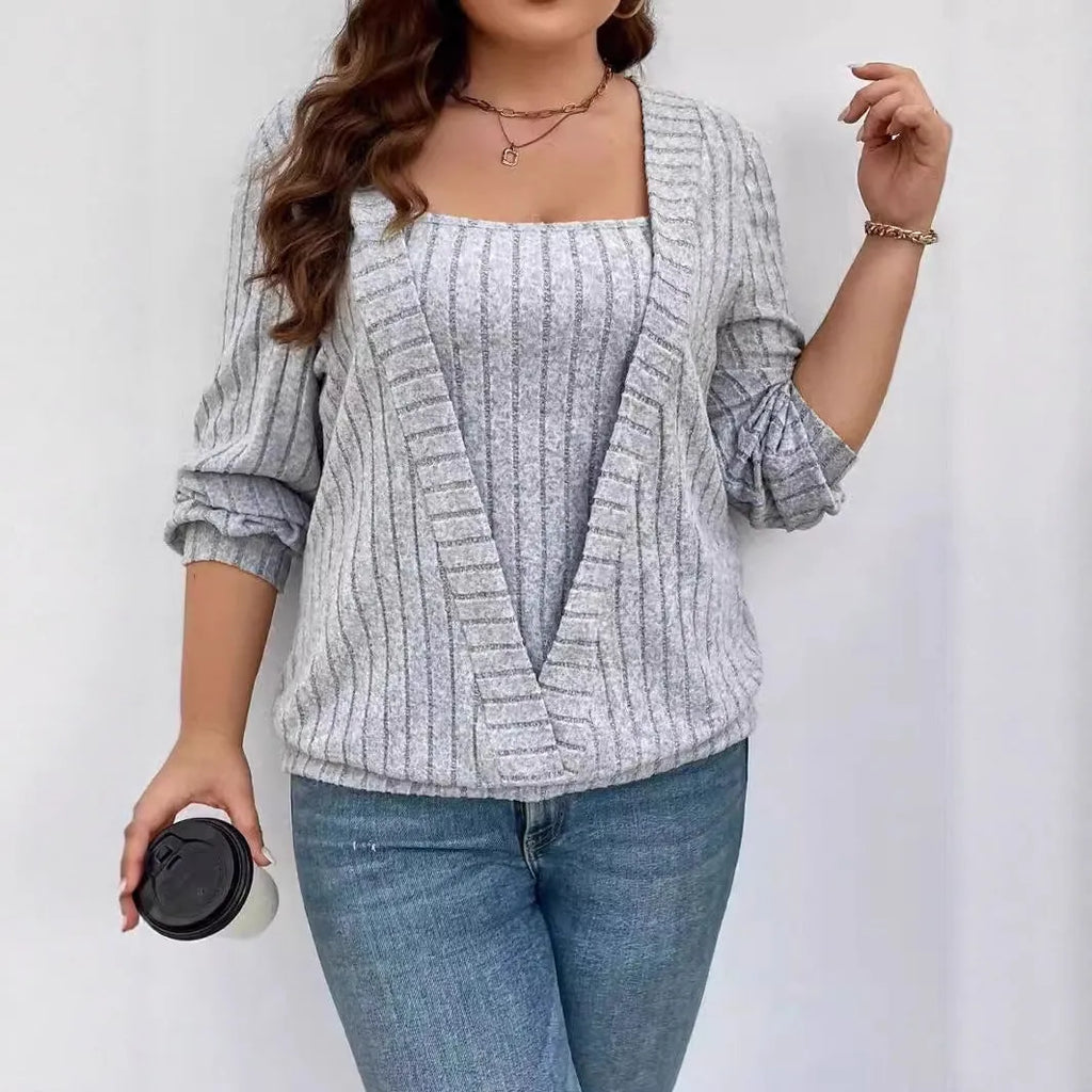 Woman wearing a solid purple V-neck long sleeve faux two-piece suit with a ribbed texture and loose fit.