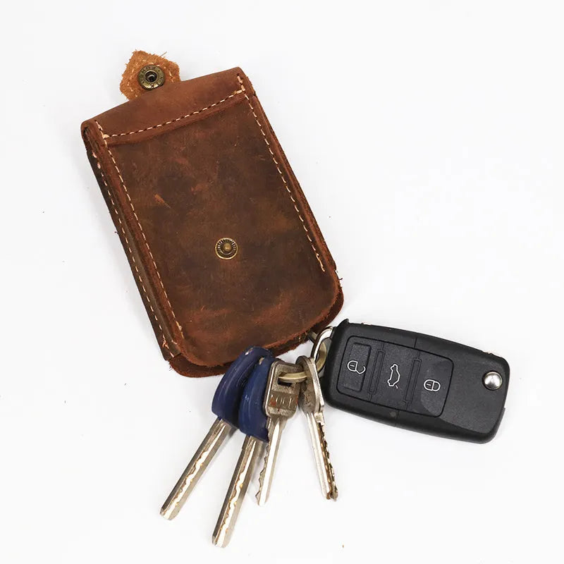 Crazy horse leather key case 7cm by 11.5cm in dark brown colour lying flat